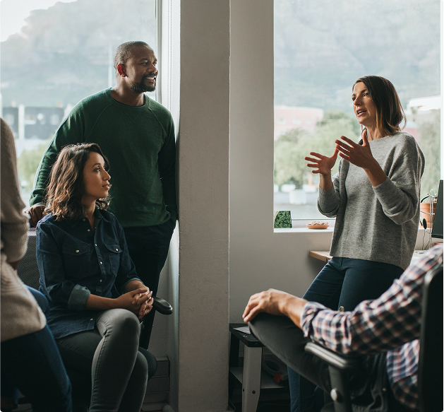 Casually dressed businesspeople having a conversation in a conference room
