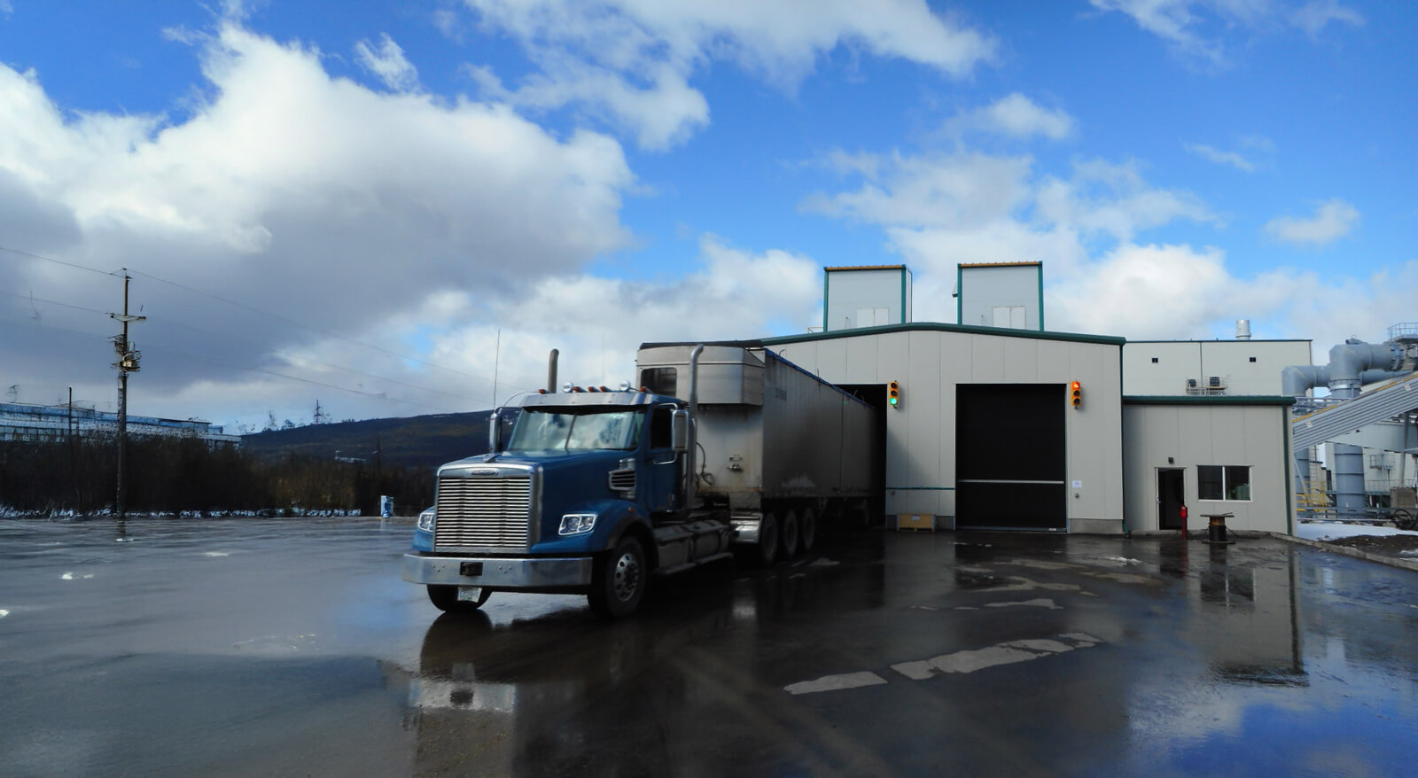 A semi truck backed into a loading dock