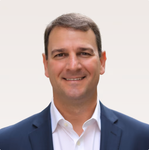 Headshot of Ben, a Preferred Solutions team member, smiling in a suit