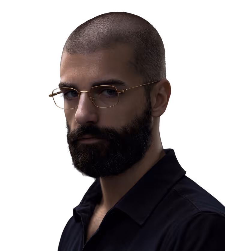 Portrait of a serious man with a shaved head, beard, and gold-rimmed glasses wearing a black shirt against a black background.
