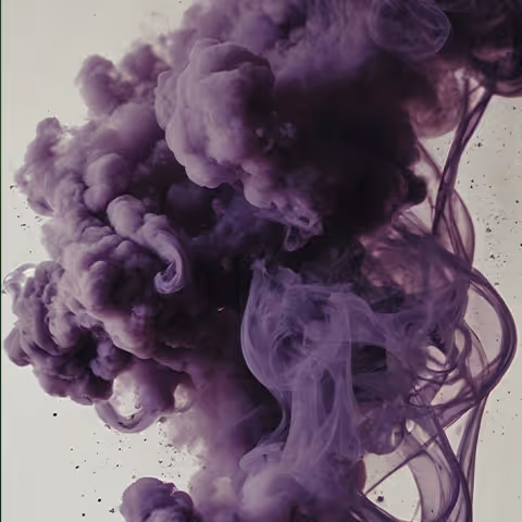 Dense swirling clouds of purple ink mixing in water against a pale background.