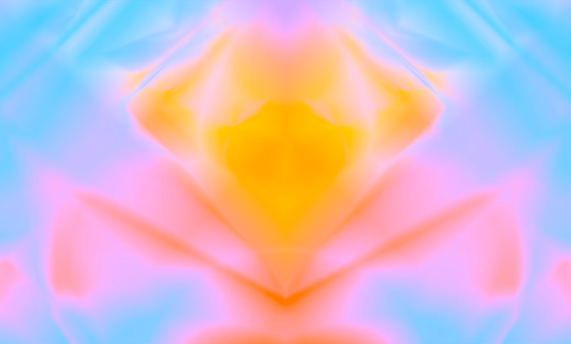 Abstract symmetrical pattern with blurred gradients in pastel blue, pink, and yellow tones.