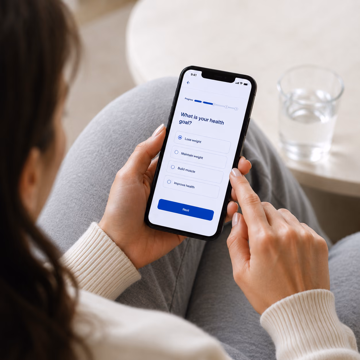 Woman signing up for Curve on her mobile phone. 