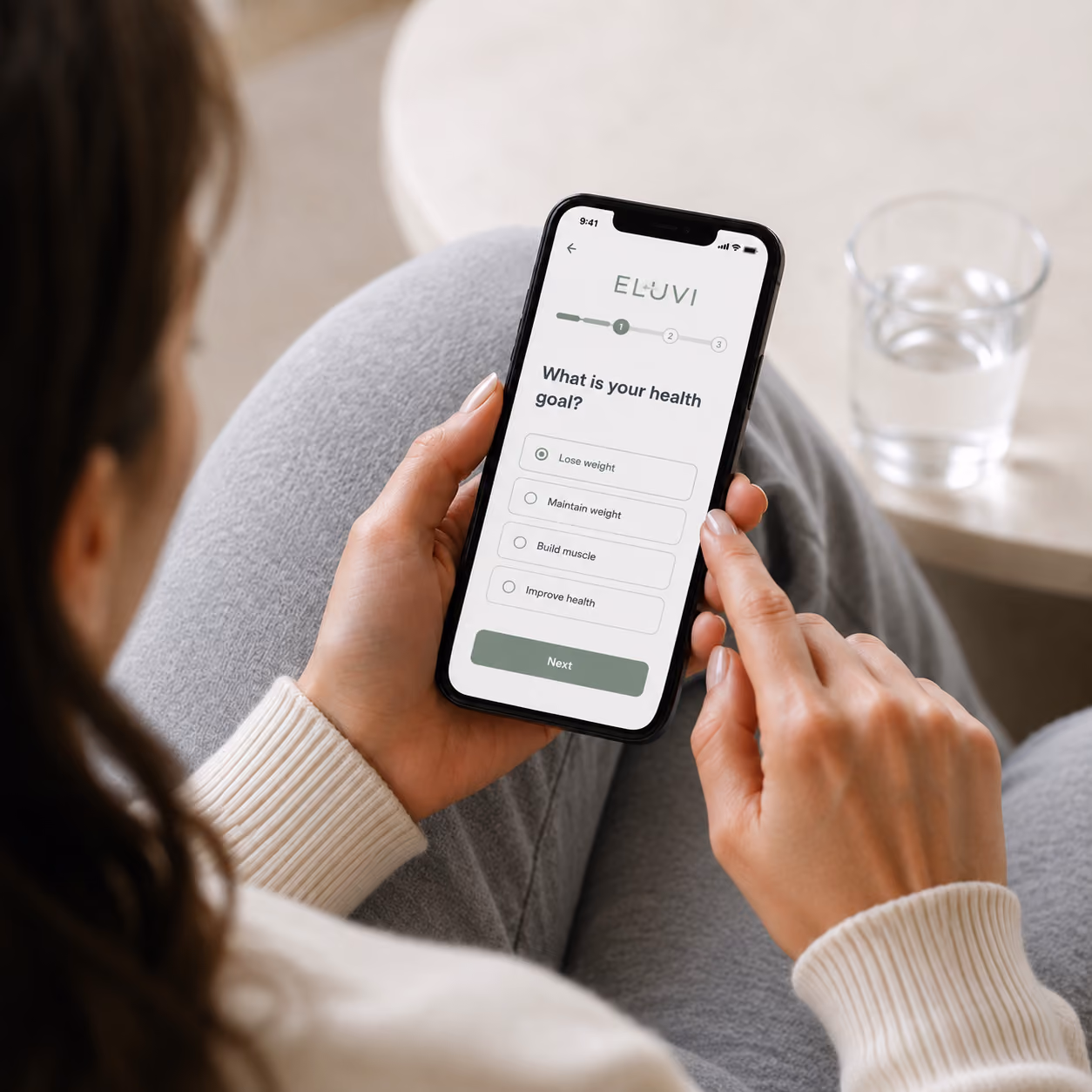 A woman on her phone going through a questionnaire for GLP-1 medication. 