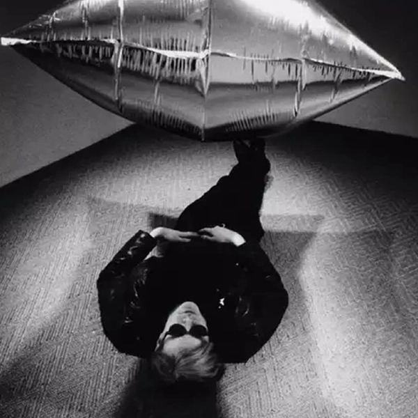 Steve Schapiro (American, 1934–2022), Andy Warhol under the Silver Cloud Pillow, New York, 1965. © Steve Schapiro and The Andy Warhol Foundation for the Visual Arts, Inc.