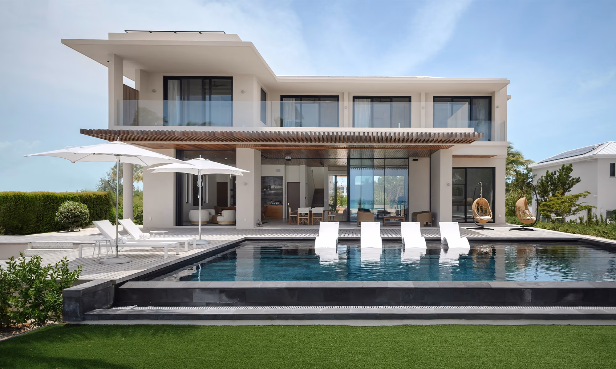 This is the Thumbnail for the Magazine Cover Grace Bay Mansion With Black Lava Stone Pool, Pickleball Court, Fire Pit & Bar item