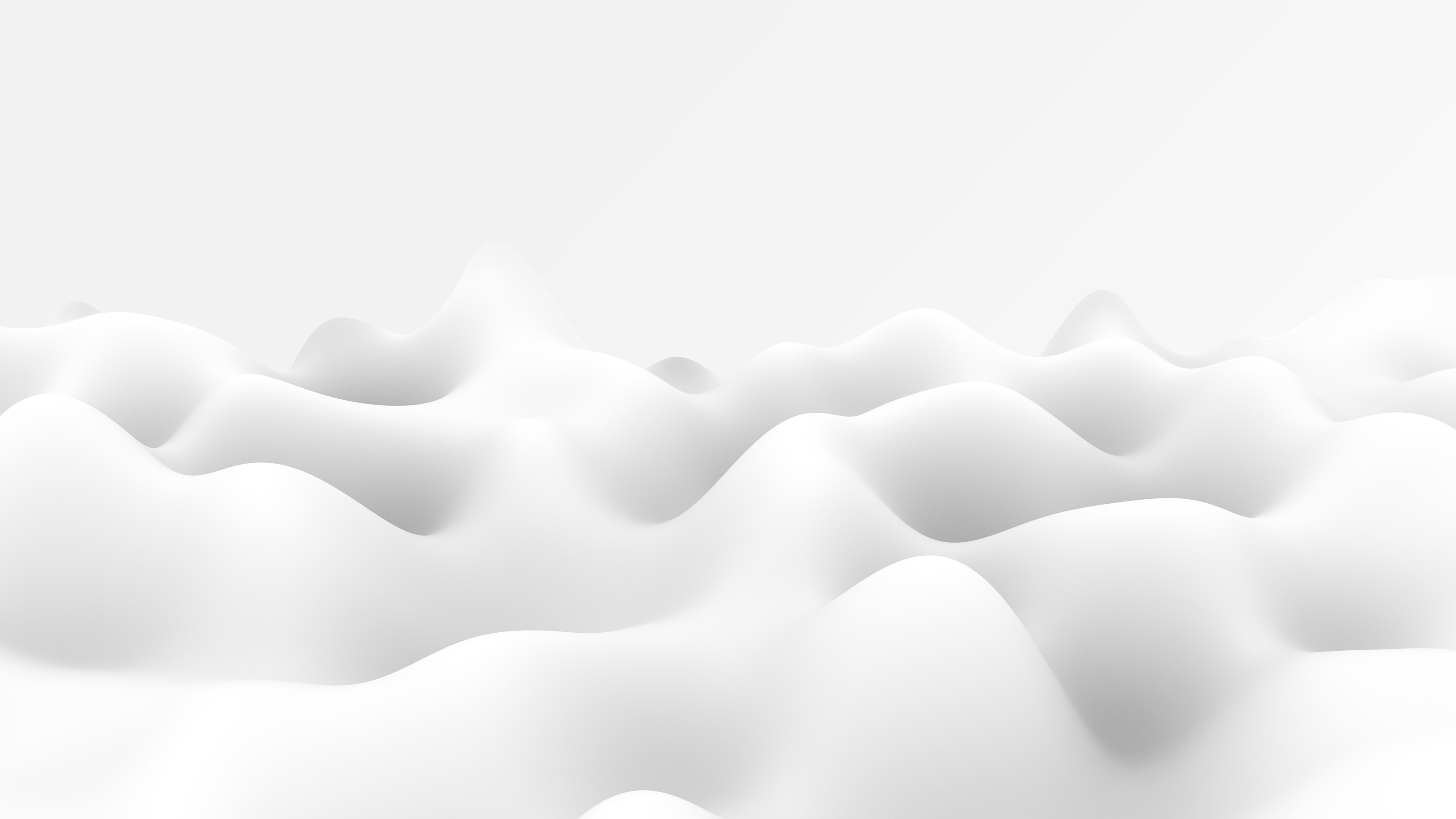 Abstract soft white undulating shapes resembling smooth hills or clouds under soft lighting.