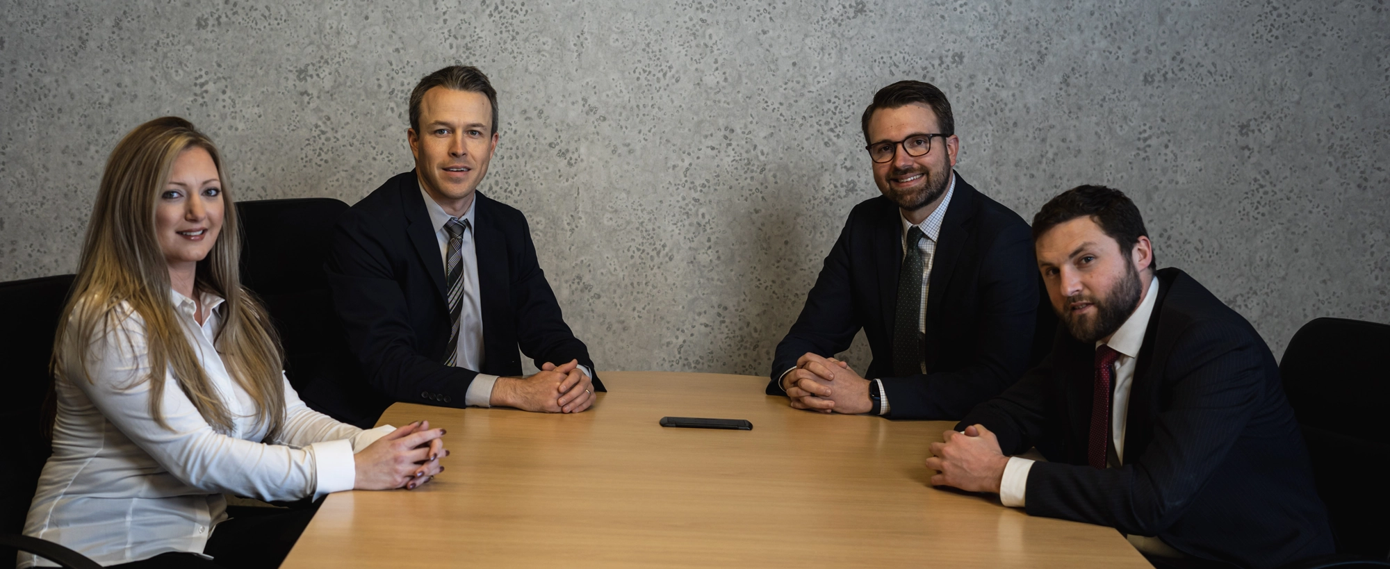 Four legal team members sitting at table