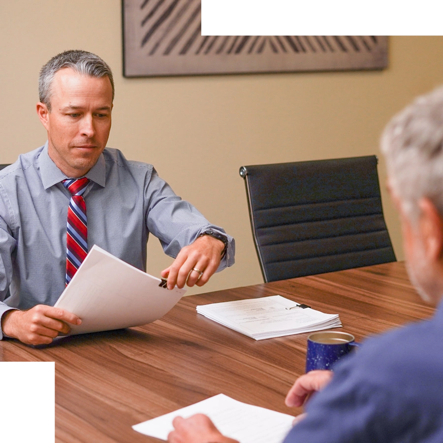 Attorney Damon Booth reviewing documents with a client
