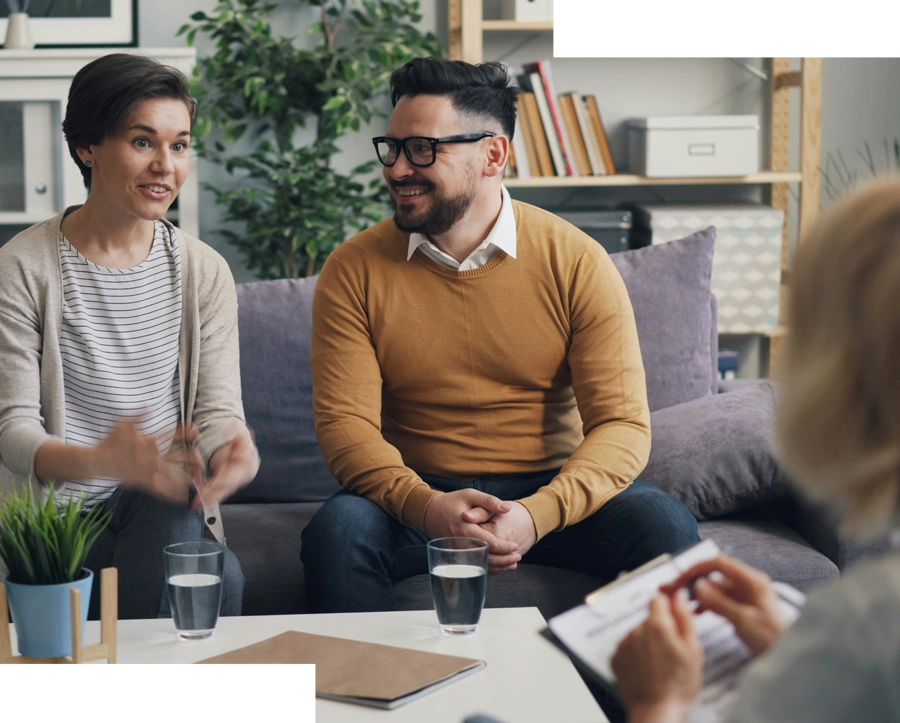 Couple speaking with counselor in a home setting