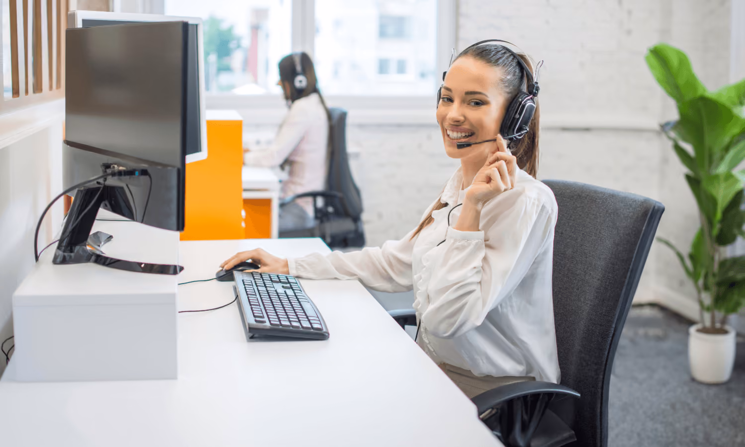 A hospital operator answering inbound calls on a headset for a healthcare system.