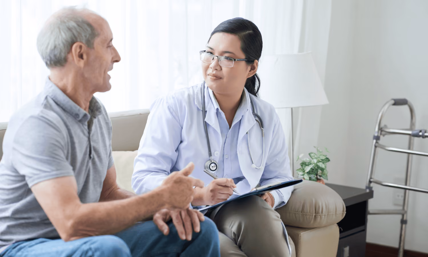A patient discusses his care with a doctor in a hospital.