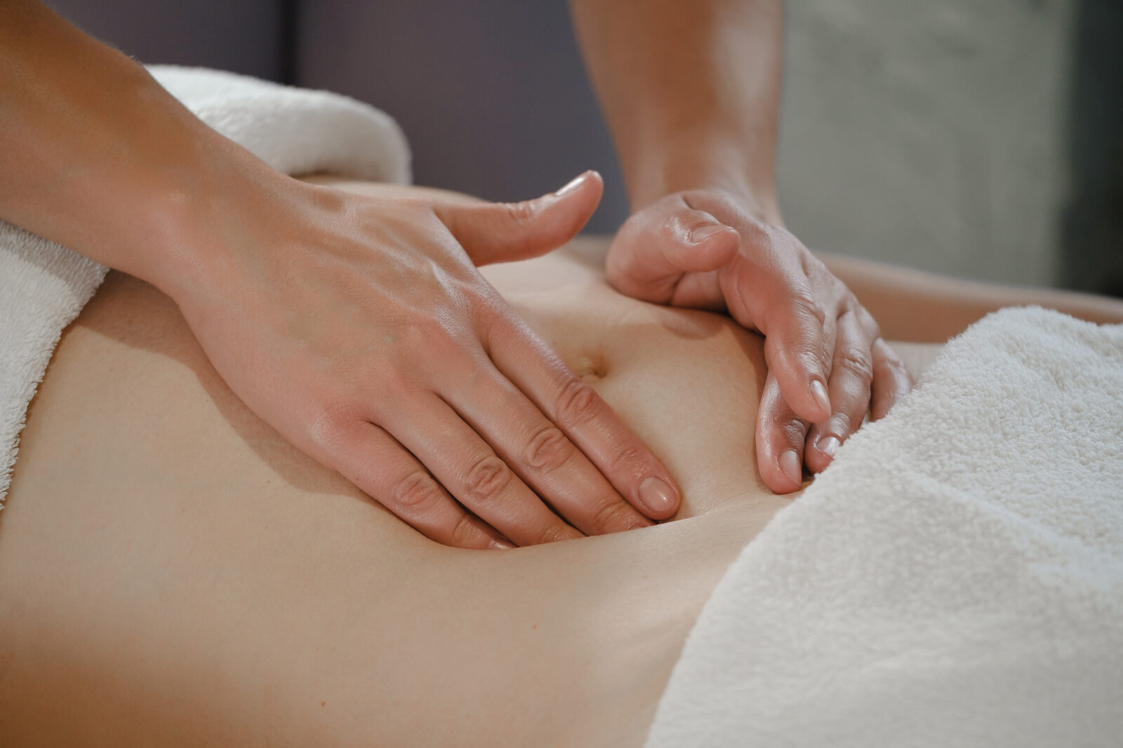 Therapist performing manual lymphatic drainage on the abdomen