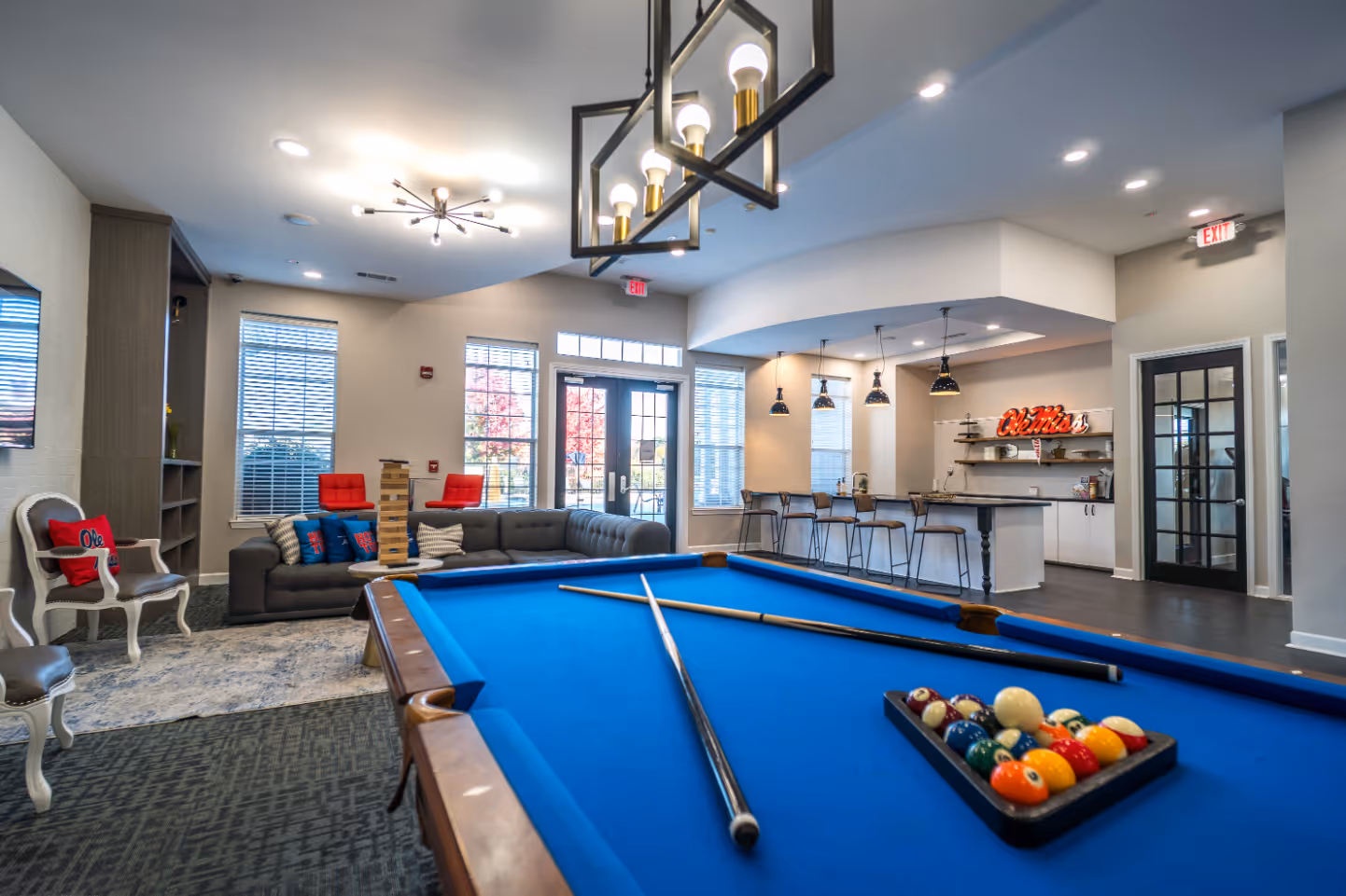 Game room featuring billiards table, sofas, and kitchenette 