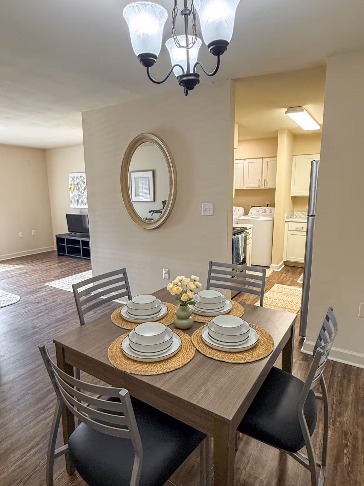 Apartment dining room with a dining table, chairs , and view into kitchen, showcasing a home interior at Rev Oxford in Oxford, MS.