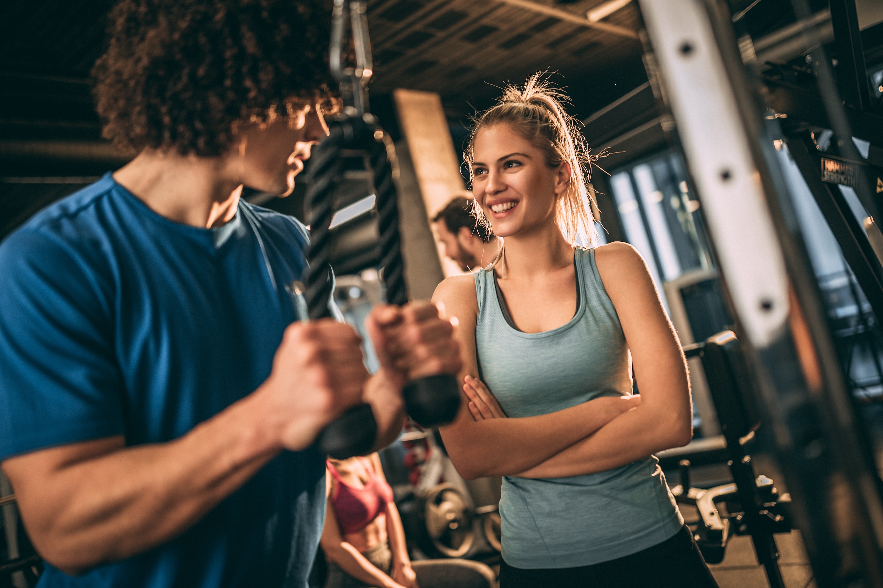 Residents working out in the state-of-the-art fitness center at Rev Oxford apartments, highlighting the luxury student housing amenities near the University of Mississippi.