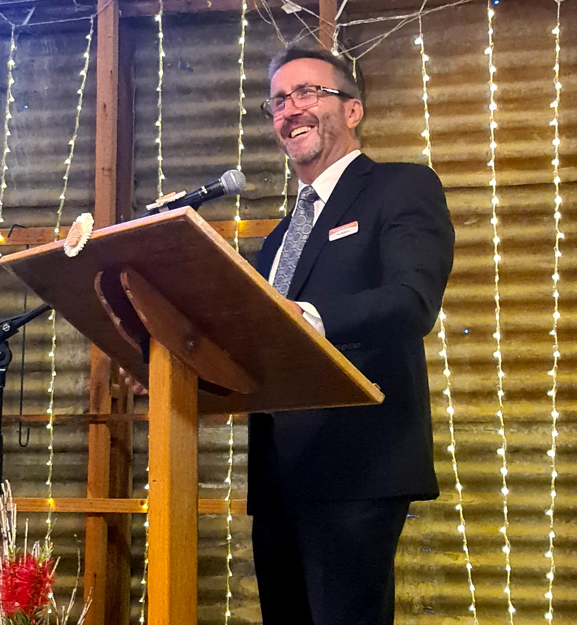 Principal behind podium giving a speech at Year 12 Graduation.