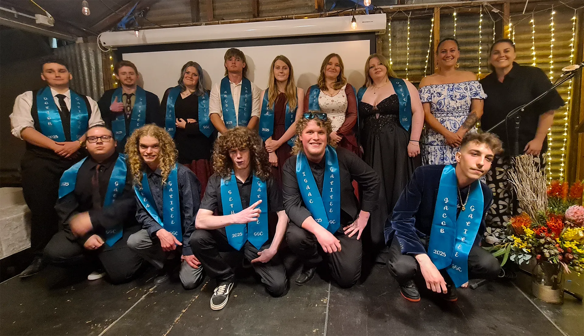 Year 12 graduates posing and smiling at camera. 