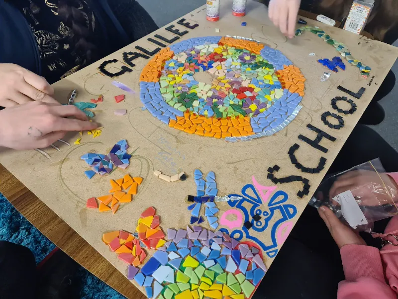Colourful mosaic artwork in progress.