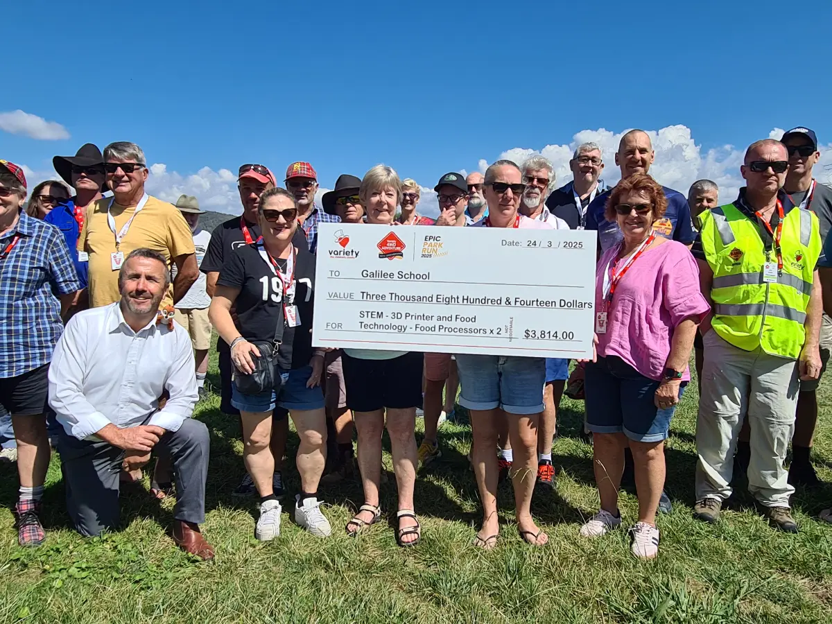 Group of people standing with an oversized check addressed to Galilee School for $3814