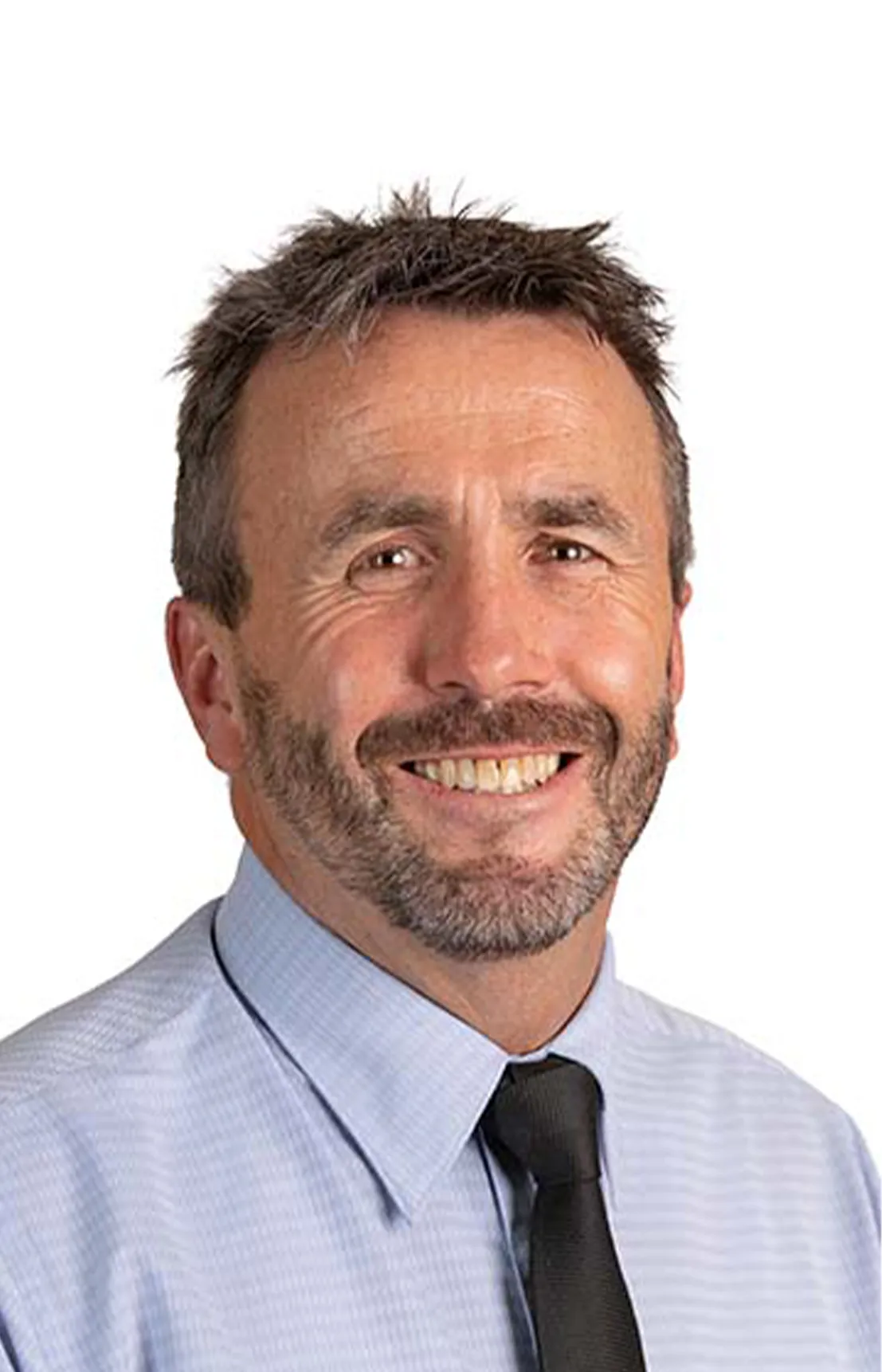 A mean wearing a shirt and tie smiling at the camera. 