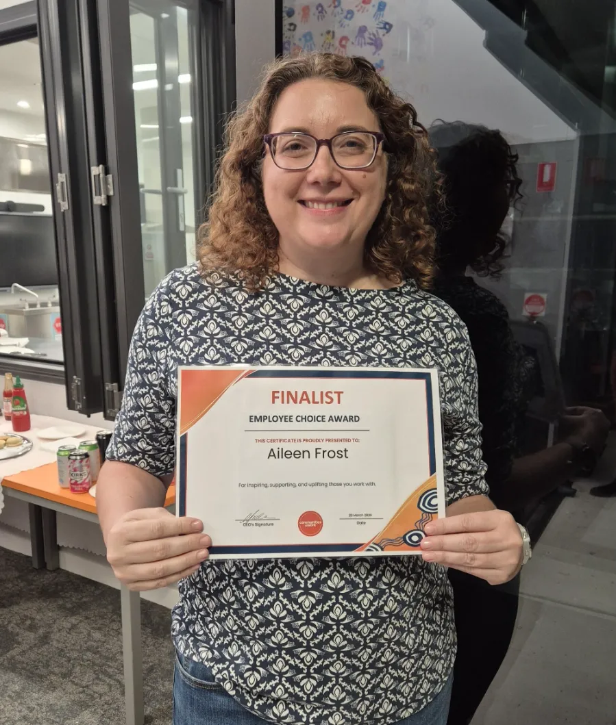 Aileen Frost holding a certificate that says finalist in employee choice award.