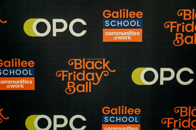 A close-up of the media wall with OPC, Galilee School and Black Friday Ball logos. 