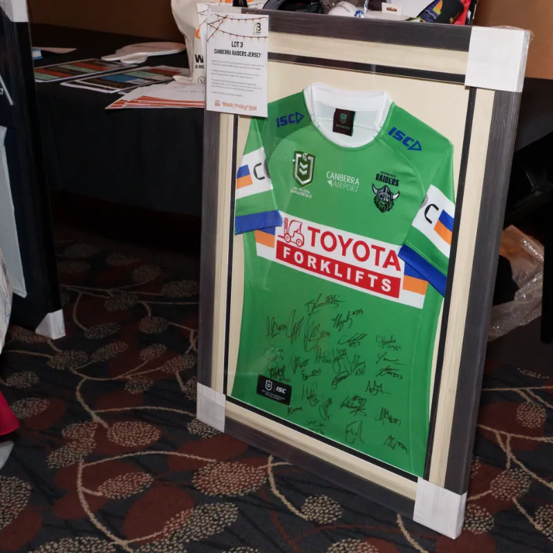 A framed and signed Canberra Raiders jersey. 