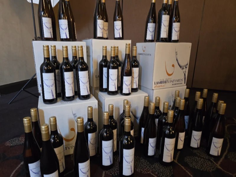 A stack of wine bottles with a white label.