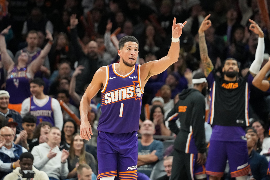 Suns G Devin Booker celebrates a 3-pointer in an NBA game.