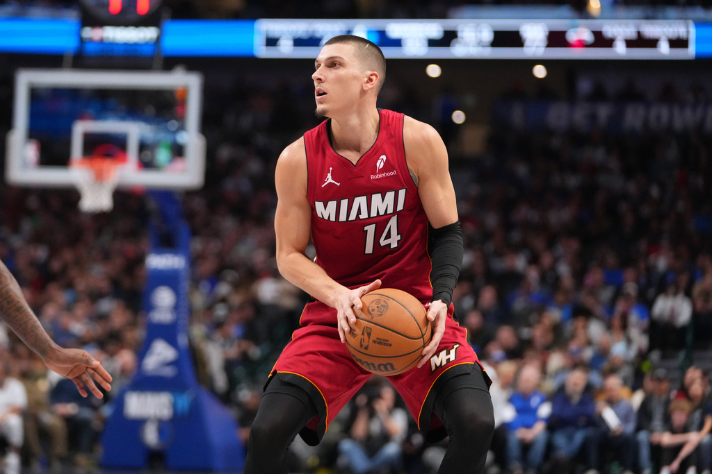 Heat G Tyler Herro passes a basketball in an NBA game.