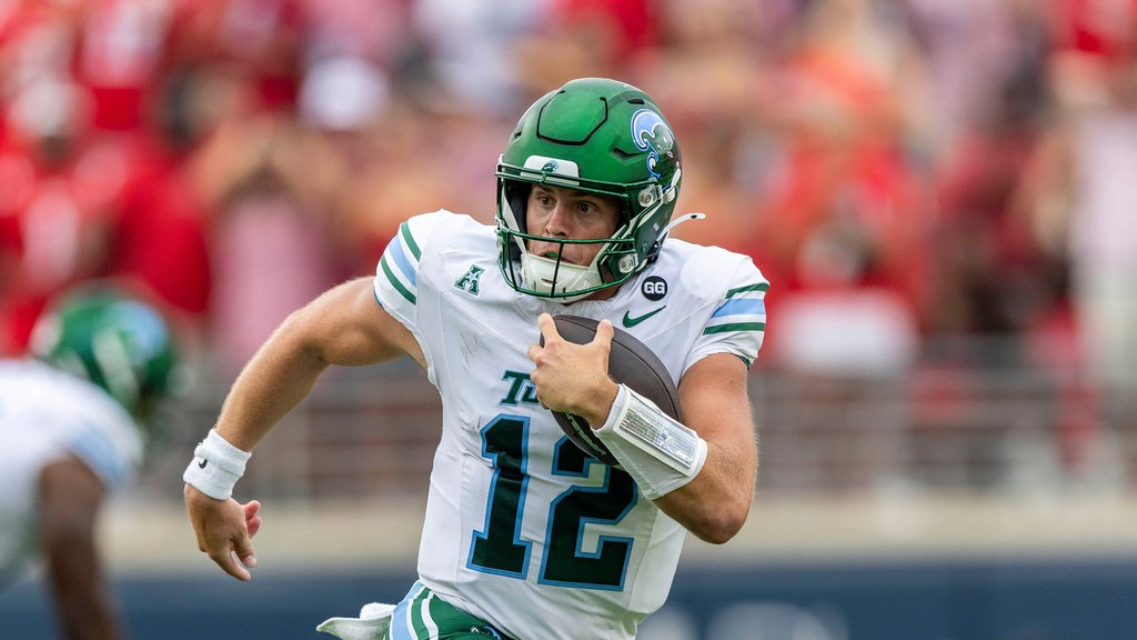 Tulane QB Jake Retzlaff carries the football in Mississippi.