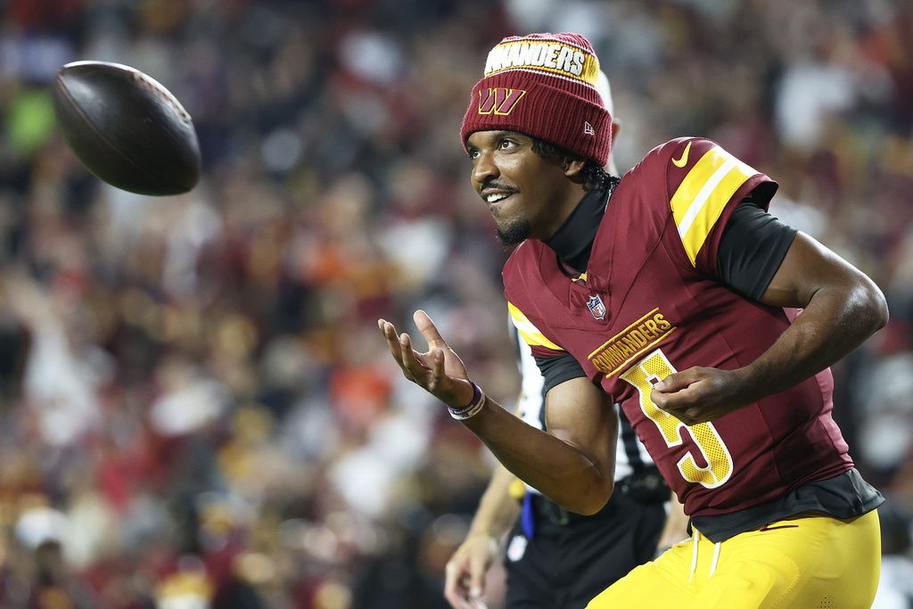 Commanders QB Jayden Daniels prepares for an NFL football game.