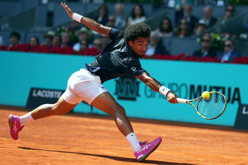France's Arthur Fils returns the ball to Italy's Jannik Sinner during their men's single semifinal match at the Madrid Open tennis tournament.