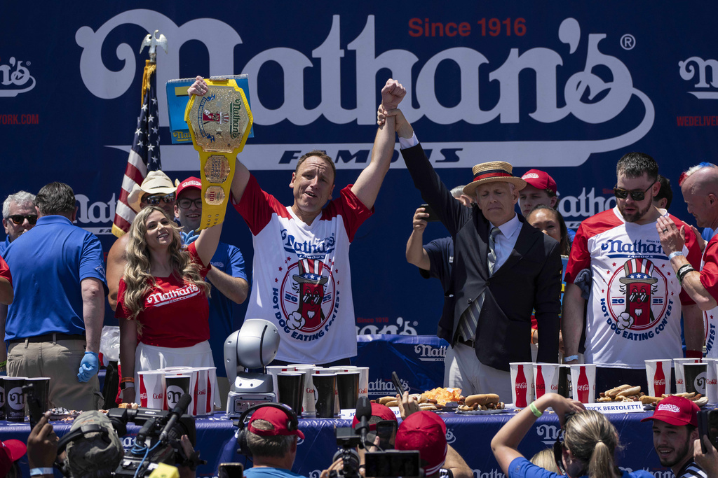 Competitive eater Joey Chestnut celebrates after winning the 2025 Nathan's Hot Dog Eating Contest.