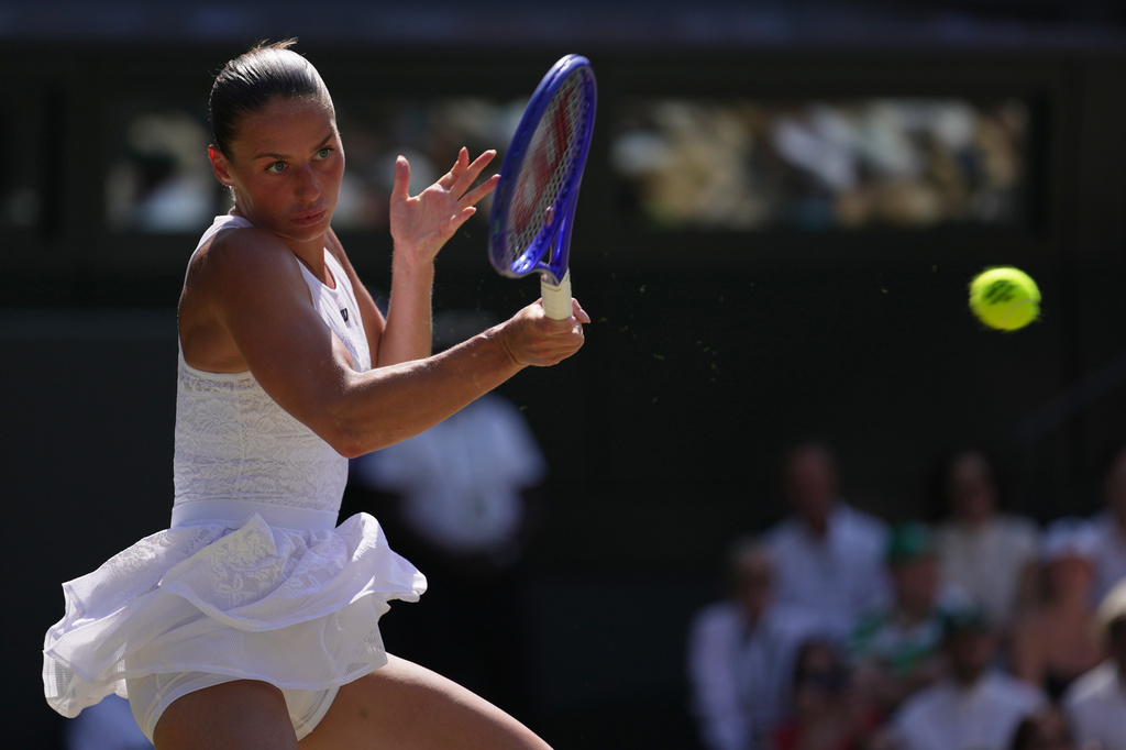Marta Kostyuk of Ukraine returns the ball to Jasmine Paolini of Italy in their quarter-final women's singles match at the Wimbledon Tennis Championships in London, Wednesday, July 8, 2026.