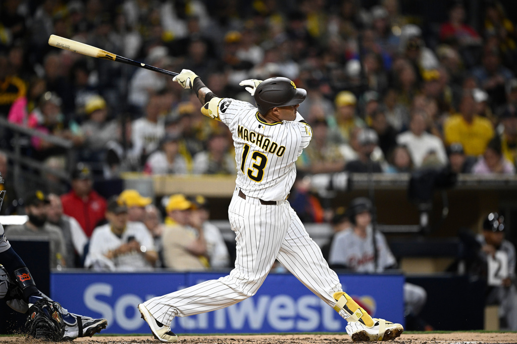 San Diego Padres' Manny Machado (13) hits a double during the fourth inning of a baseball game against the Detroit Tigers Friday, March 27, 2026, in San Diego.