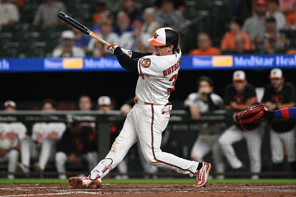 Baltimore Orioles catcher Adley Rutschman (35) follows through on a two run double against the Chicago Cubs in the seventh inning of a baseball game on Tuesday, July 7, 2026 in Baltimore, Md.