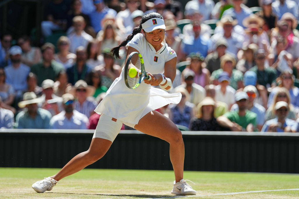 Alexandra Eala plays a return vs. Jasmine Paolini during the women's singles fourth round match at Wimbledon.