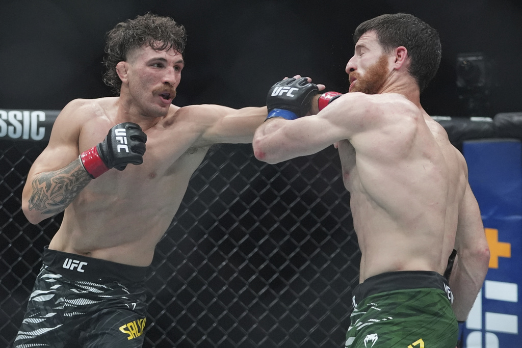 Australia's Quillan Salkilld lands a punch in a a lightweight bout at the UFC 316 mixed martial arts event Saturday, June 7, 2025 in Newark, N.J.