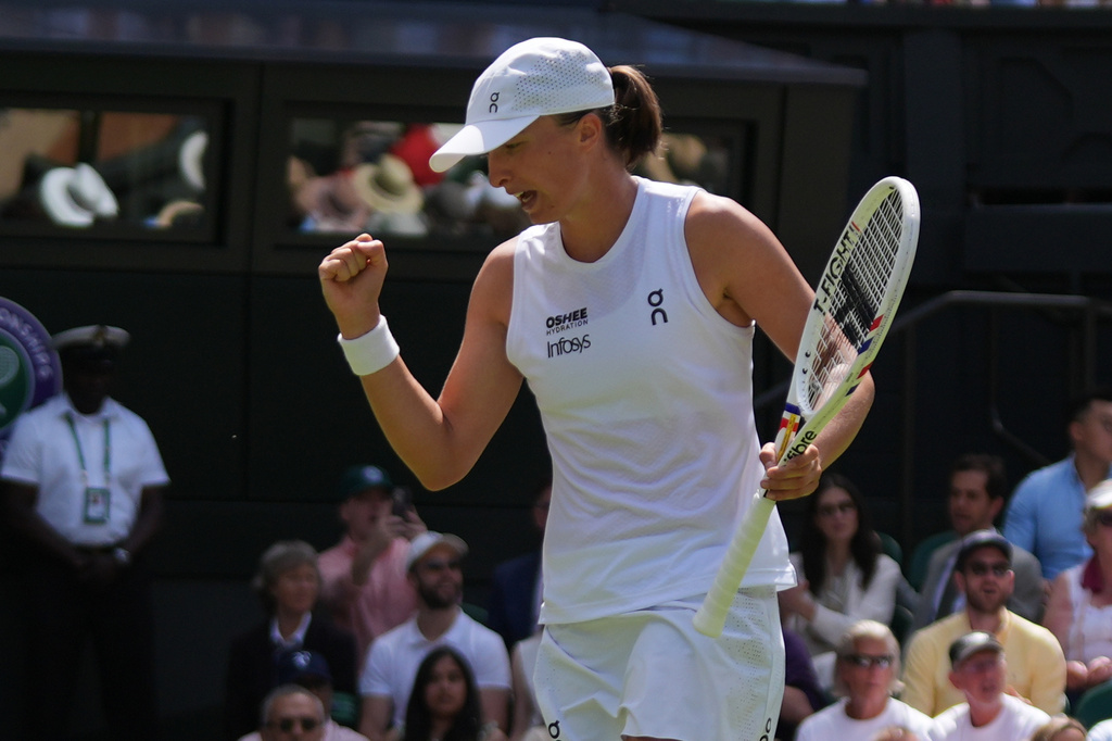 Professional tennis players Marta Kostyuk and Iga Swiatek during a high-intensity hard court match.