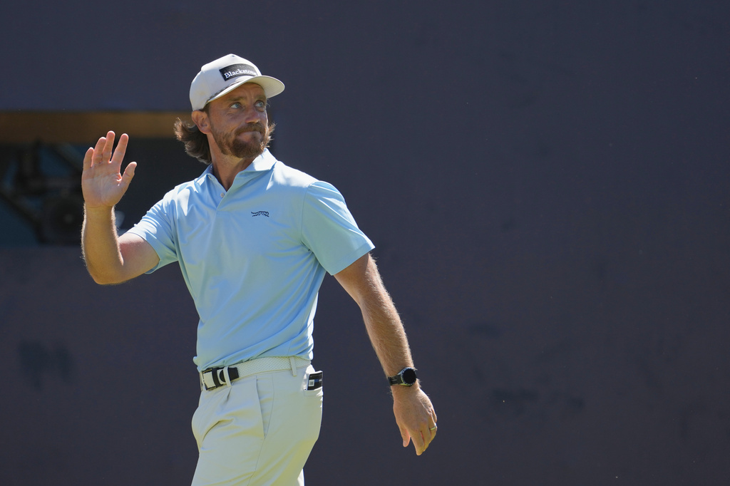 PGA Tour star Tommy Fleetwood arrives and waves to the crowd at the British Open golf tournament.