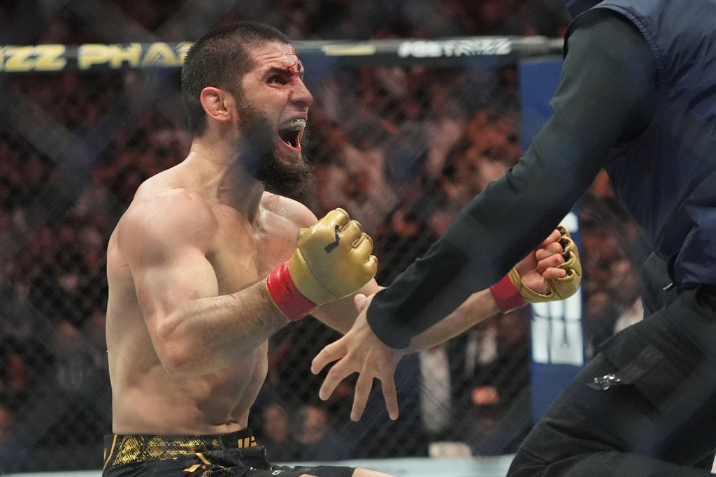 Islam Makhachev celebrates after defeating Dustin Poirier in a lightweight title bout at UFC 302.
