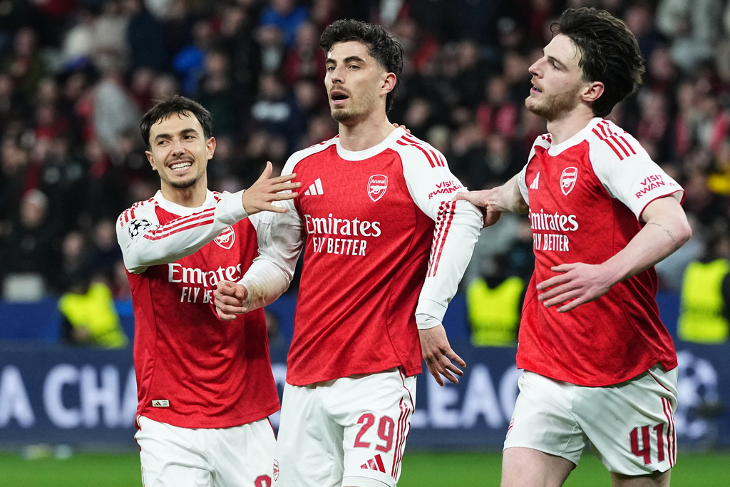 Arsenal's Declan Rice, Martin Zubimendi, and Kai Havertz after scoring a penalty vs. Bayer Leverkusen.