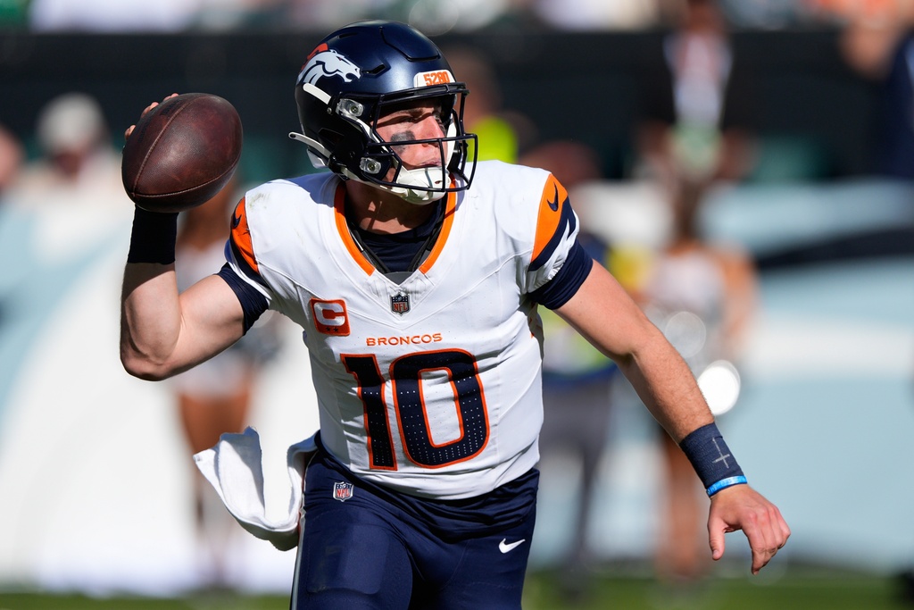Denver Broncos QB Bo Nix looks to pass during an NFL game against the Philadelphia Eagles.
