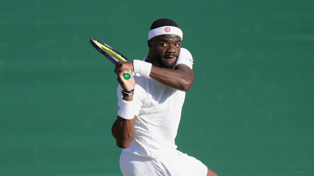Frances Tiafoe returns the ball to Jan Choinski in a second round match at the Wimbledon.