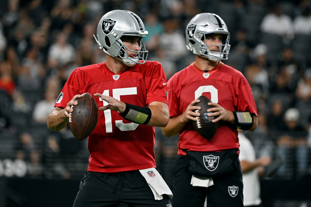 Las Vegas Raiders quarterbacks Fernando Mendoza (15) and Kirk Cousins (8) participate during an NFL football practice Tuesday, Aug. 11, 2026, in Las Vegas.
