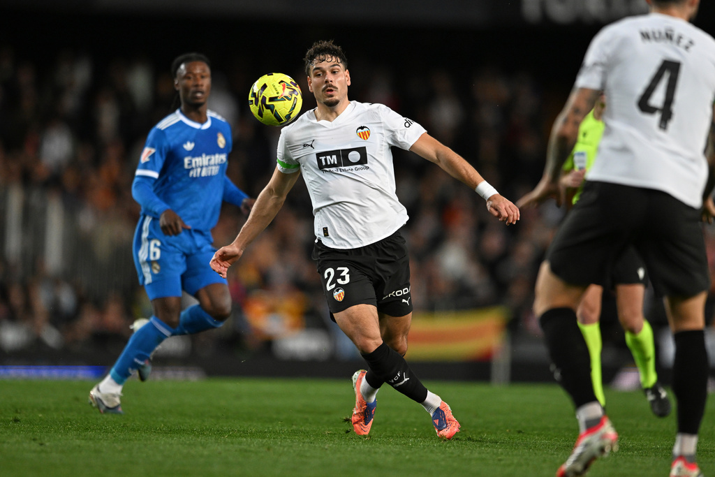 Valencia's Filip Ugrinic controls the ball during a La Liga match against Real Madrid.
