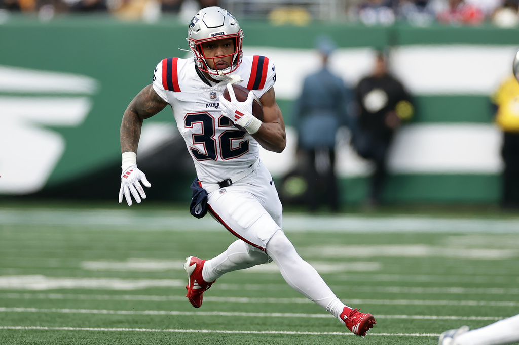 New England Patriots running back Treveyon Henderson (32) runs with the ball during an NFL football game against the New York Jets, Sunday, Dec. 28, 2025, in East Rutherford, N.J.