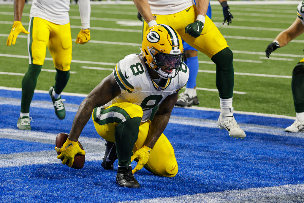 Packers RB Josh Jacobs celebrates after scoring a TD against the Lions.